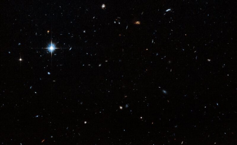 Star field showing distant galaxies and mostly blackness.