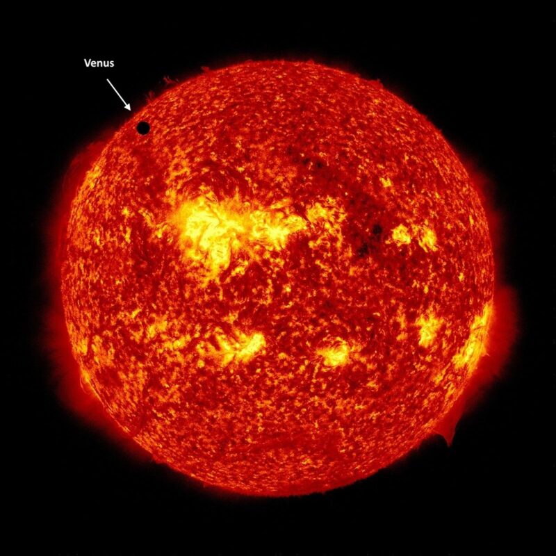 Spacecraft image of sun, with black round dot in upper left.