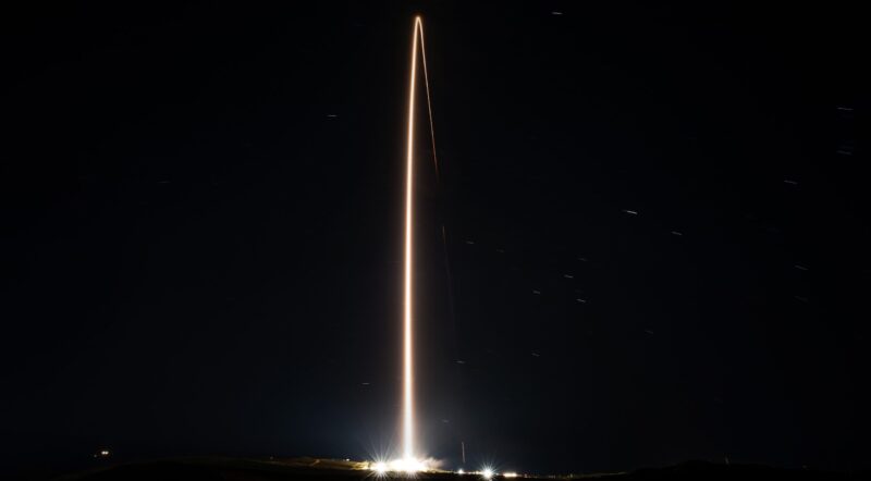 10,000 Starlink satellites: In black night, a line of light arcs from the launch site off toward space.