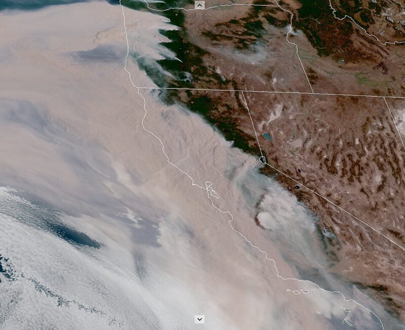Satellite image of California and Oregon with thick tan smoke flowing westward.