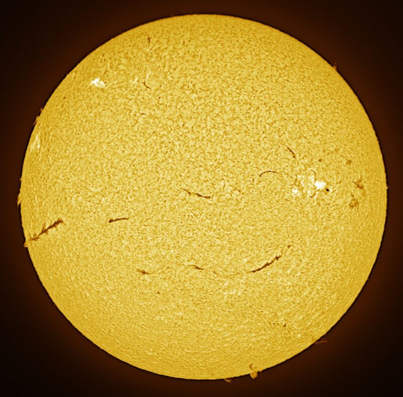 The sun, seen as a large yellow sphere with a mottled surface.