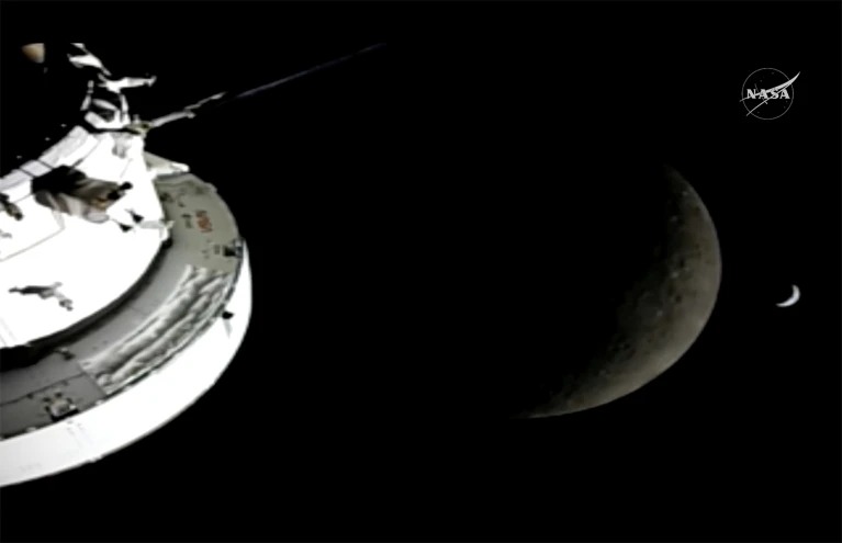 Artemis 2 spacecraft on the left, a crescent moon in the center and a tiny crescent Earth on the right.