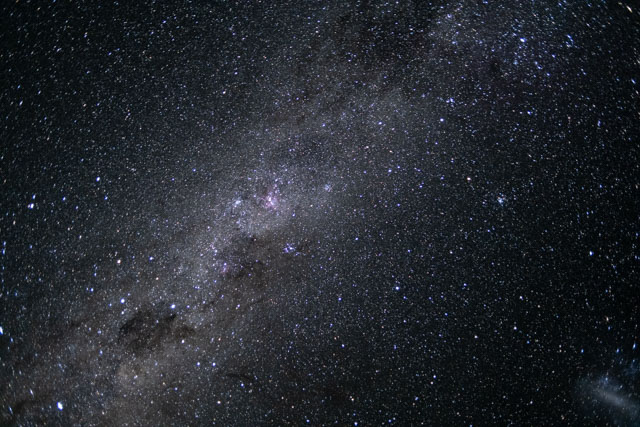 The starry band of the Milky Way with some cloudy patches of gas and dust.