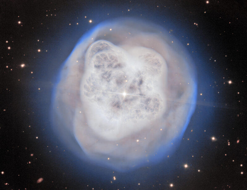 Crystal Ball Nebula: A translucent sphere of white cloud with tendrils inside and a bright core on a starry background.