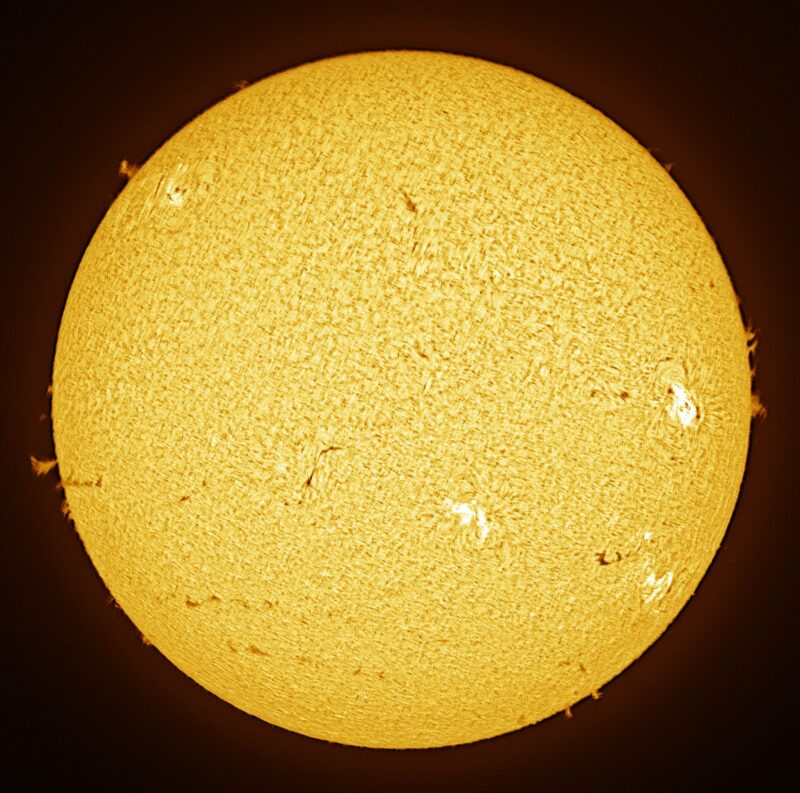 The sun, seen as a large yellow sphere with a mottled surface.