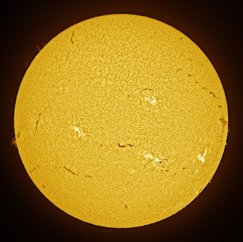The sun, seen as a large yellow sphere with a mottled surface.