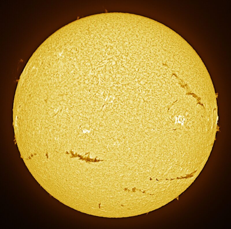 The sun, seen as a large yellow sphere with a mottled surface.