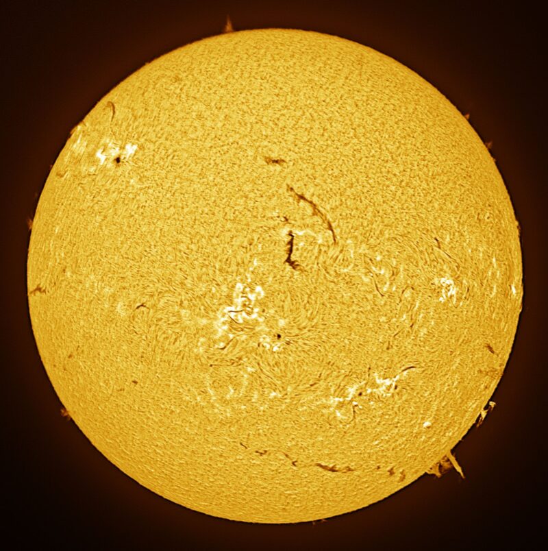 The sun, seen as a large yellow sphere with a mottled surface.