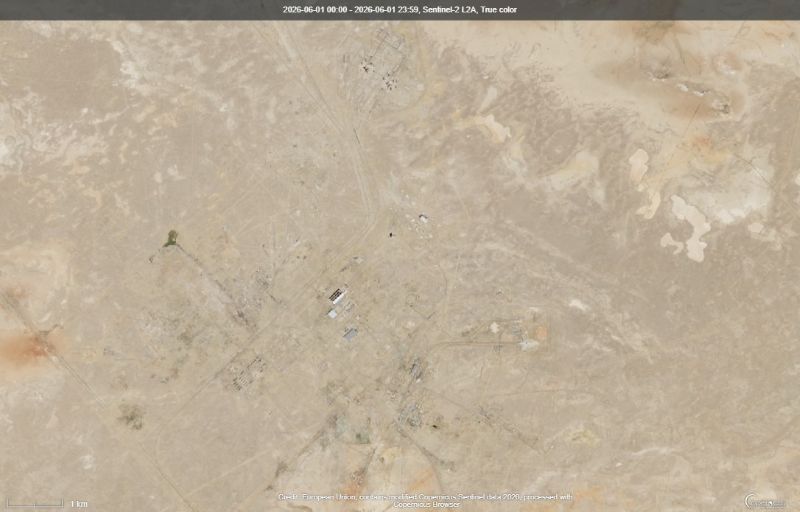 A vast expanse of tan with small buildings in white and hard-to-see roads.