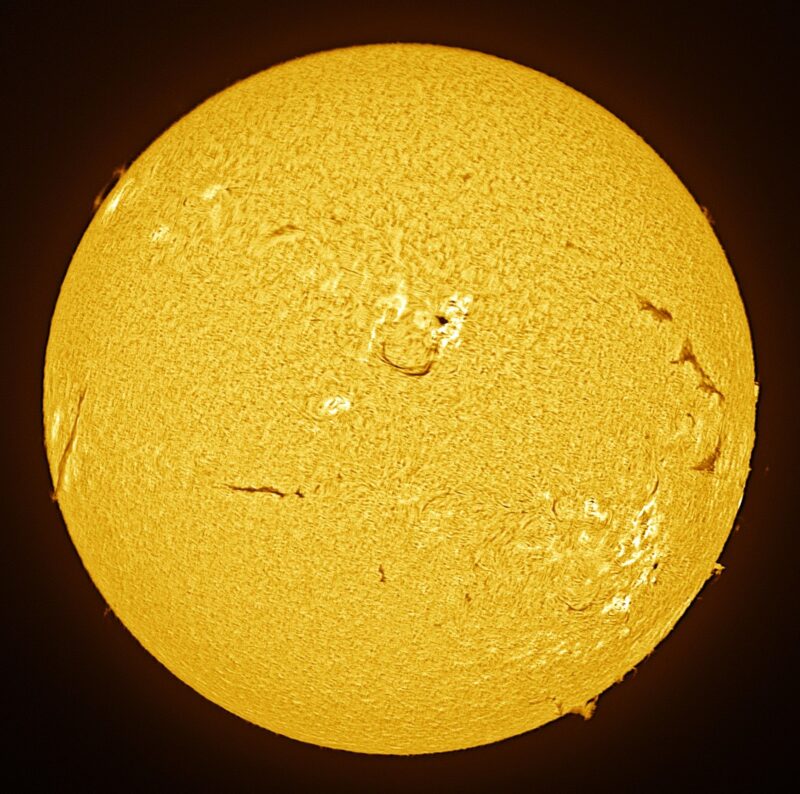 The sun, seen as a large yellow sphere with a mottled surface.