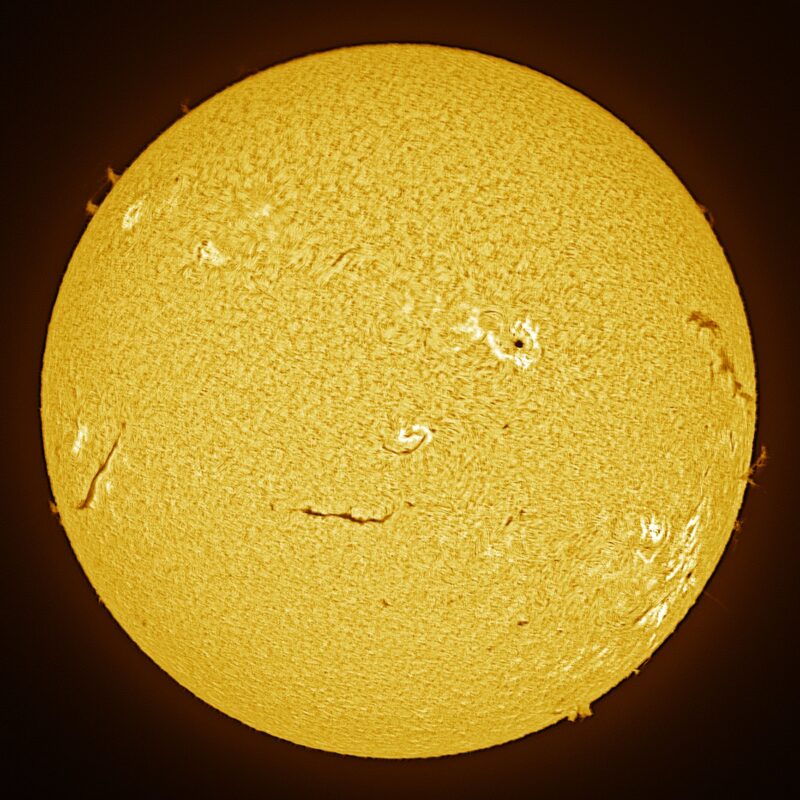 The sun, seen as a large yellow sphere with a mottled surface.