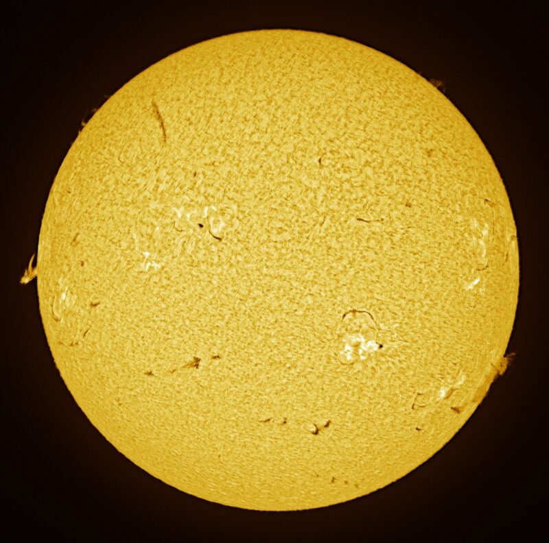 The sun, seen as a large yellow sphere with a mottled surface.