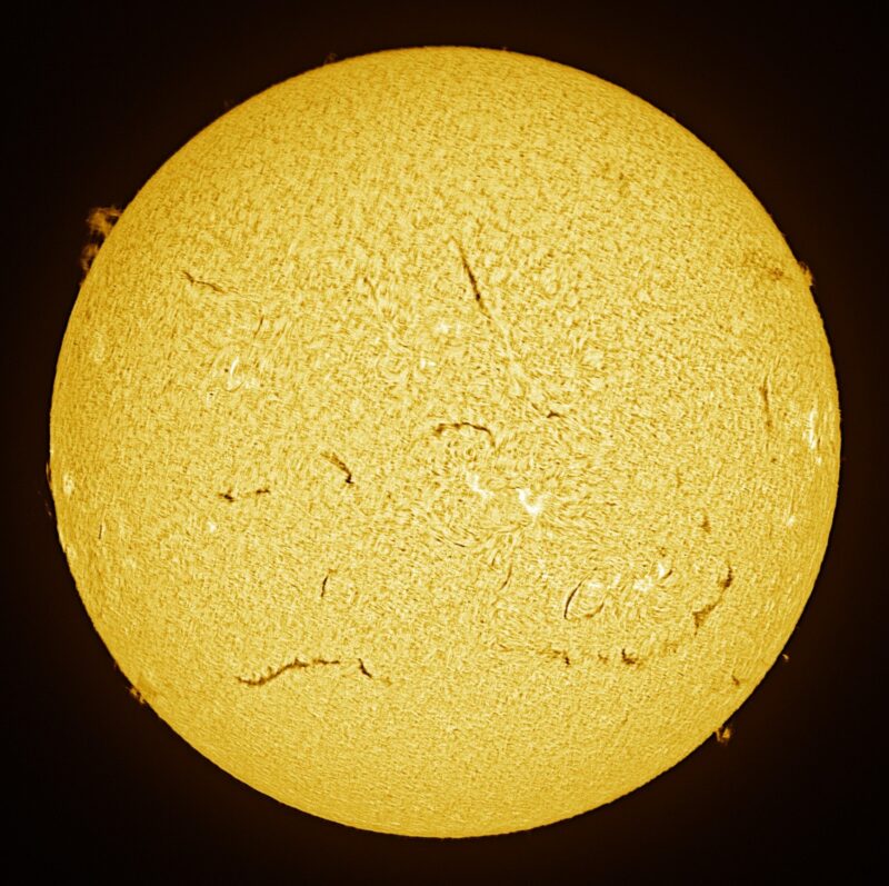 The sun, seen as a large yellow sphere with a mottled surface.
