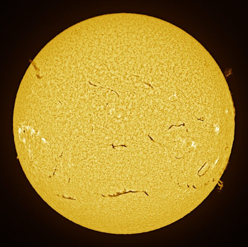 The sun, seen as a large yellow sphere with a mottled surface.