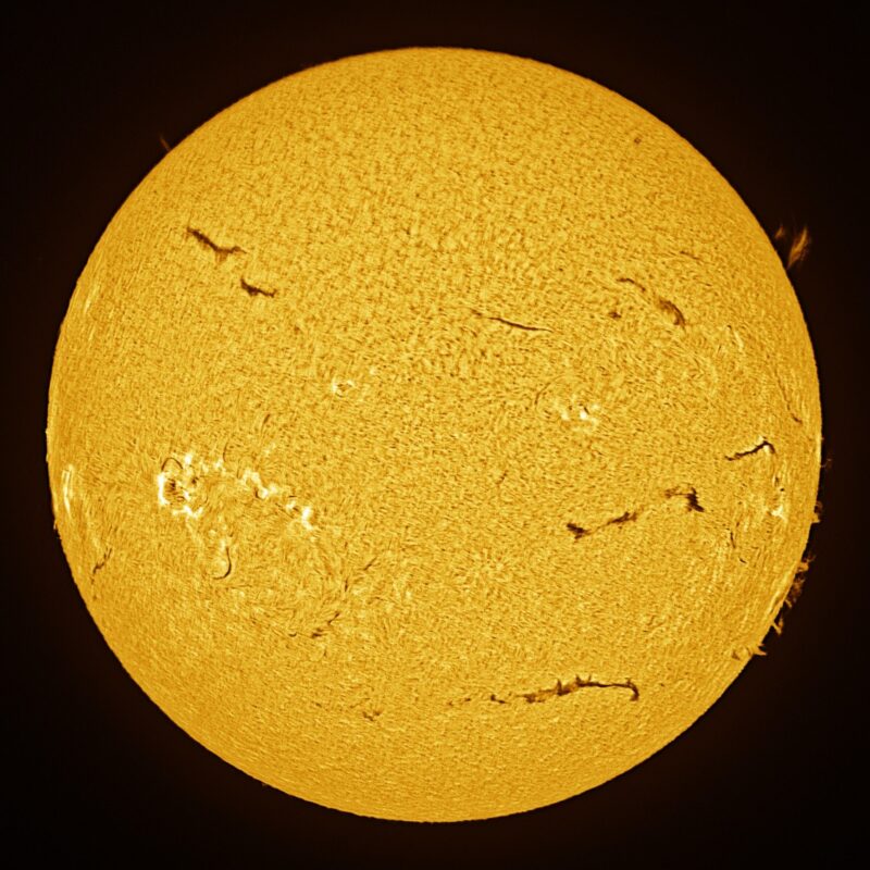 The sun, seen as a large yellow sphere with a mottled surface.