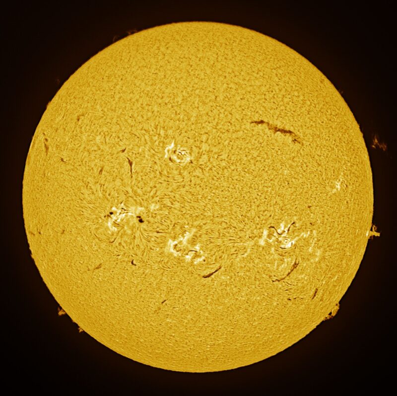 The sun, seen as a large yellow sphere with a mottled surface.