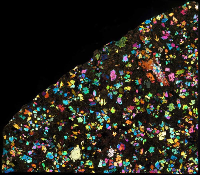 Rare meteorite: Multicolored flecks on a black background.