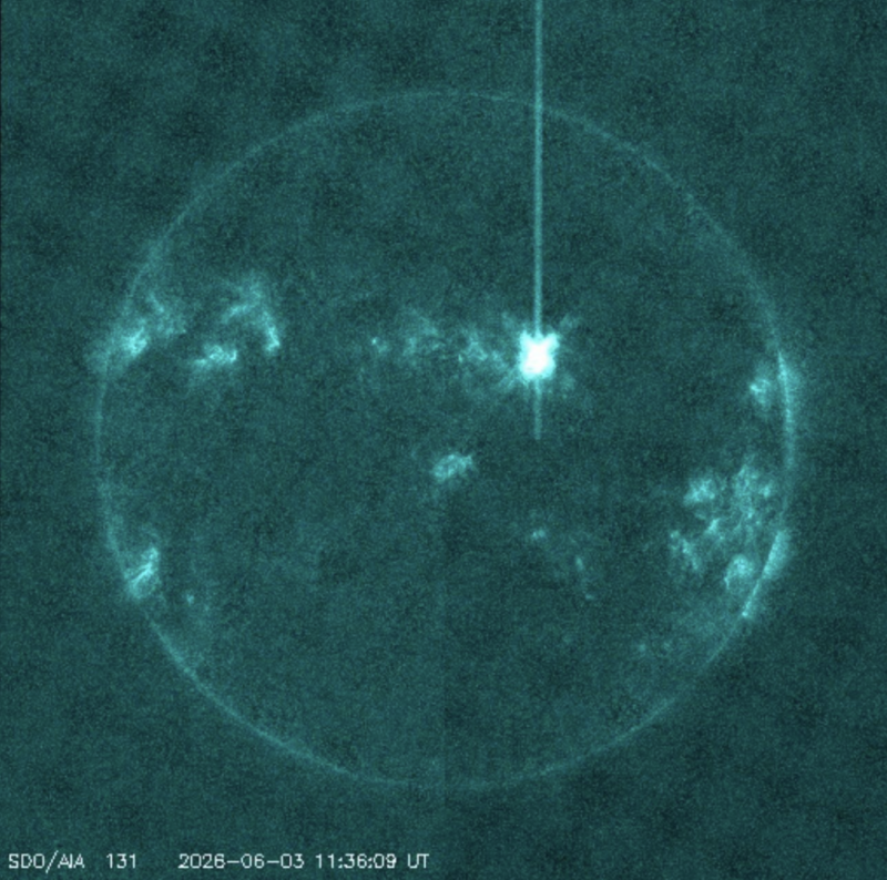 Solar ultraviolet image showing a bright solar flare near the center-right of the Sun, with active regions visible across the solar disk.