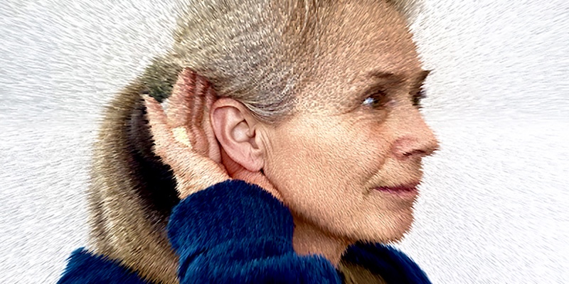 The Hum: A pixelated image of a blonde woman holding her hand behind her ear.