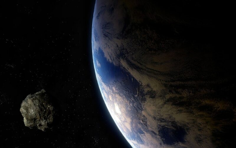 Large asteroid: Earth on the right with a smaller rocky body on the left.