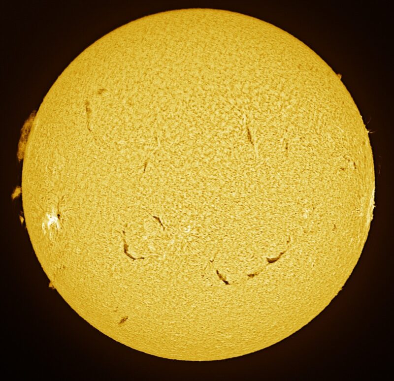 The sun, seen as a large yellow sphere with a mottled surface.