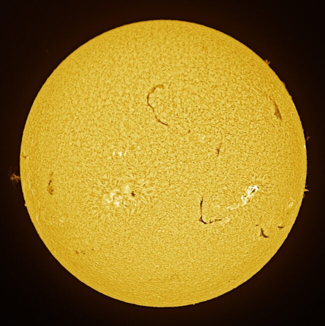 The sun, seen as a large yellow sphere with a mottled surface.