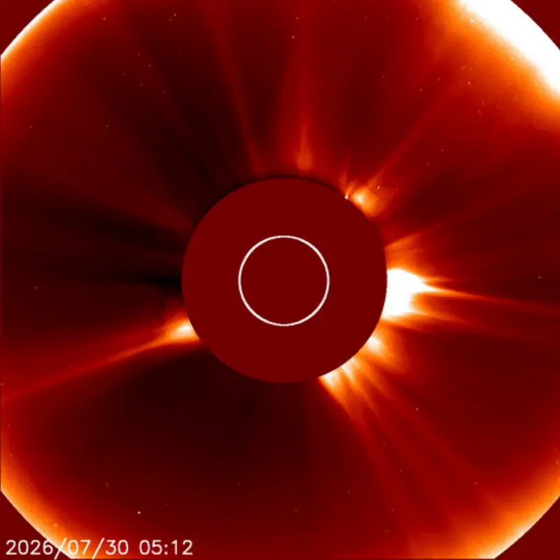 The sun, with the bright center blocked out and glowing gas streaming out all around, and a small bright dot near it.