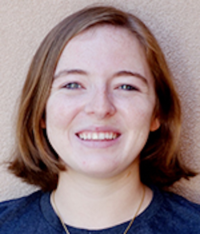 Smiling young woman with reddish brown hair.
