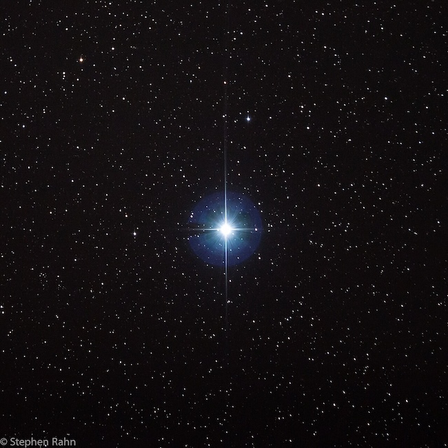 Bright star in the middle of a starfield.