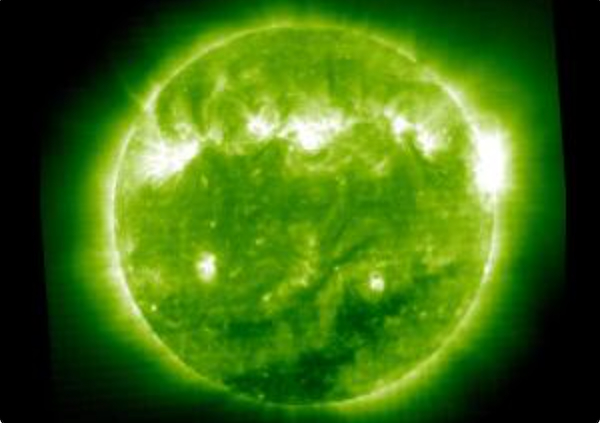 10 cool things about stars: A glowing green circle with green interior and brighter streaks within it.