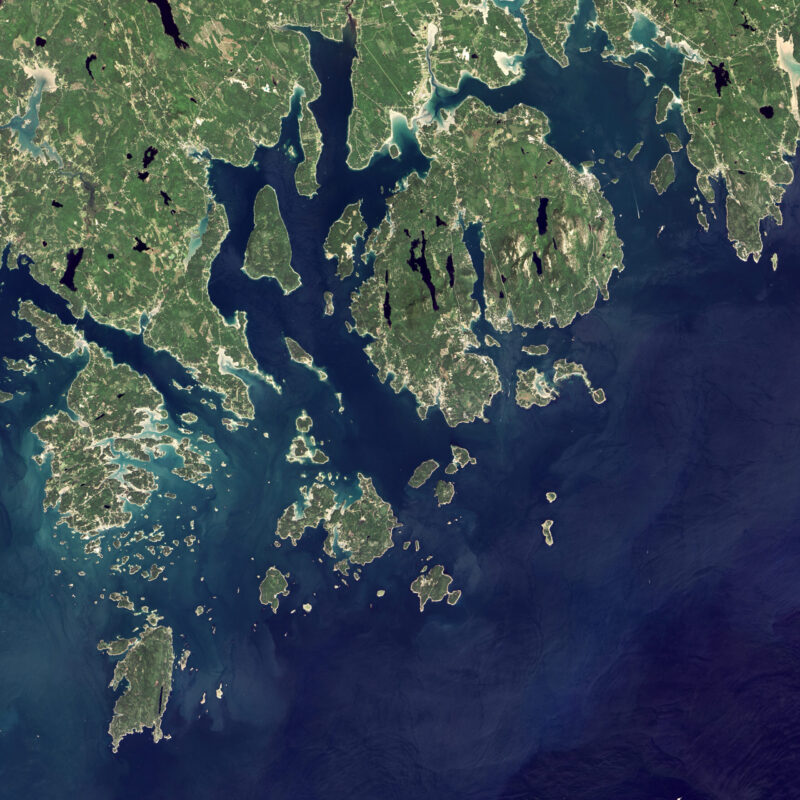 Green land with many islands and blue water off to the right and below.