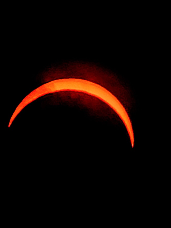 Large yellow crescent over a solid black background.