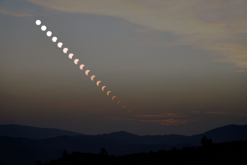 A collage with 20 crescent suns in a row over a gray background.