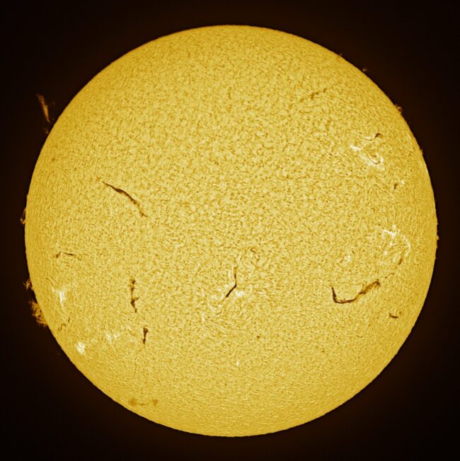 The sun, seen as a large yellow sphere with a mottled surface.