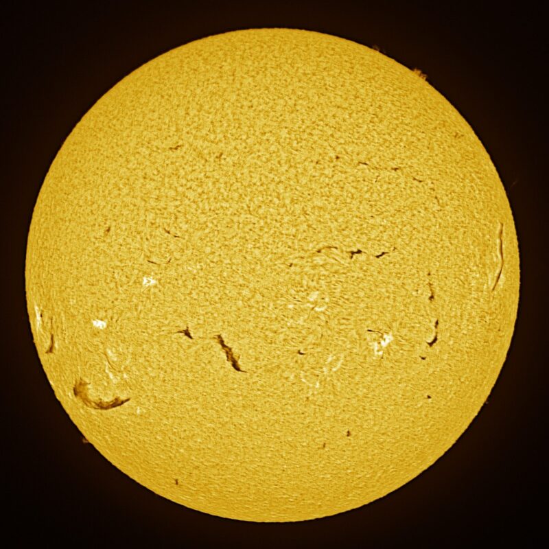 The sun, seen as a large yellow sphere with a mottled surface.