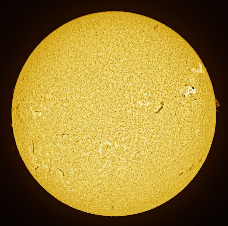 The sun, seen as a large yellow sphere with a mottled surface.
