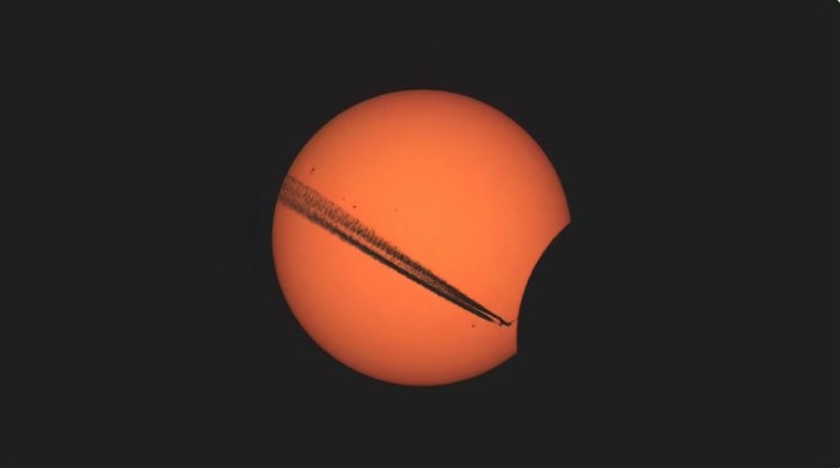 Photo showing the sun with the moon partially covering its lower-right edge.