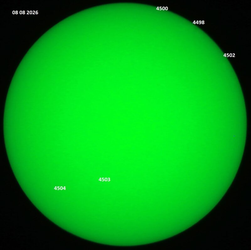The sun, seen as a green sphere with dark spots, each labeled.
