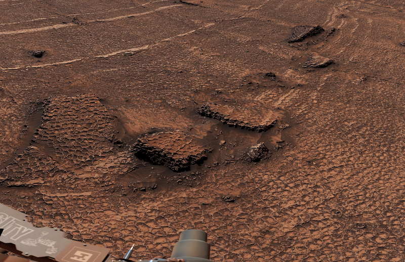 Martian honeycombs: Brownish terrain with many small polygon-shaped cracks in the ground.