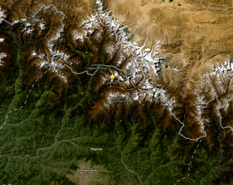 Nepal flash flood: View of landscape from satellite with snow-capped mountains and a star and green valley sloping away.