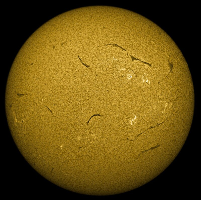 The sun, seen as a large yellow sphere with a mottled surface.