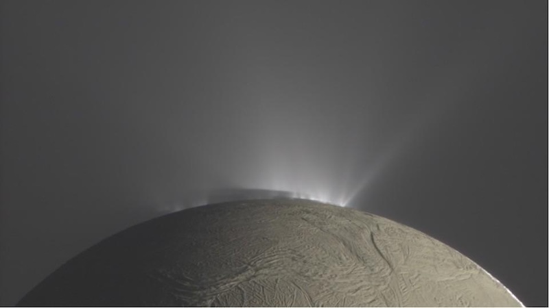 Life on Enceladus: Brownish planet-like body with wrinkled surface. Sprays of water vapor are coming out of cracks in the surface.