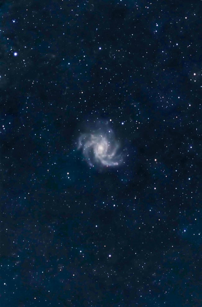 A face-on spiral galaxy with a glowing central core.