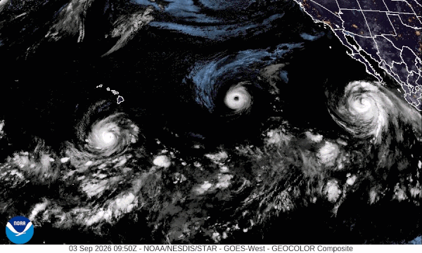 Hurricane triplets: Night view of Pacific with 3 white whirling storms.