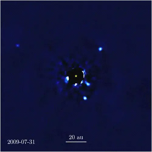 A short movie showing a black filled circle with a small yellow star in the centre, surrounded by blue-white noise, and with small white dots circling around.