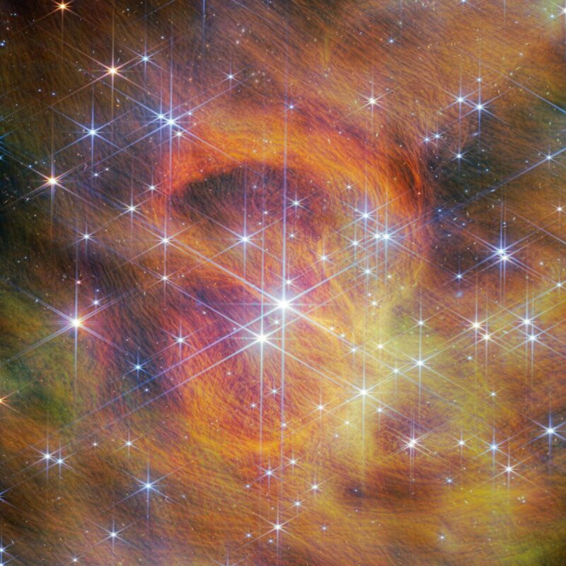 Dozens of scattered brilliant stars surrounded by an yellow-brown swirl of gas and dust.