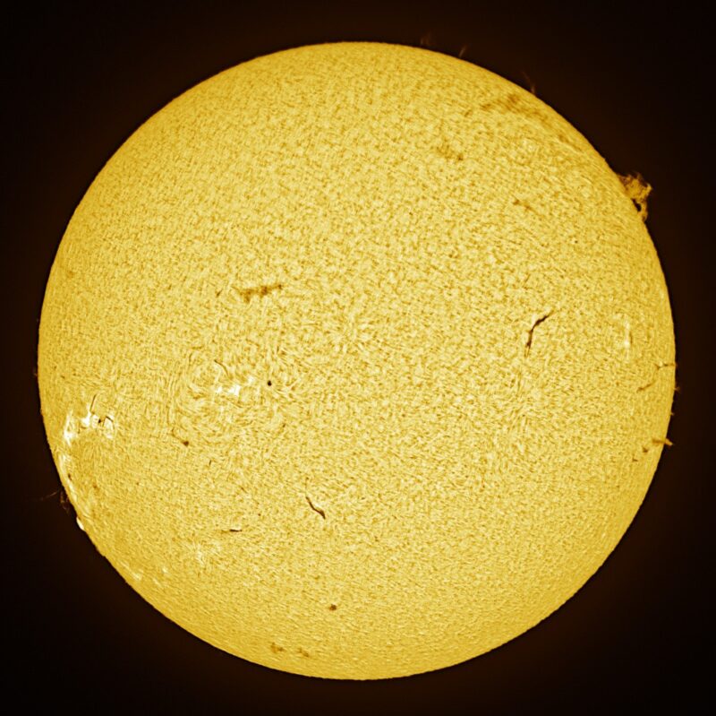 The sun, seen as a large yellow sphere with a mottled surface.