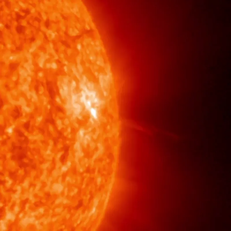 Sunspot region AR4521 flaring on the sun's northwest edge, with jets and small prominences lifting plasma into space.