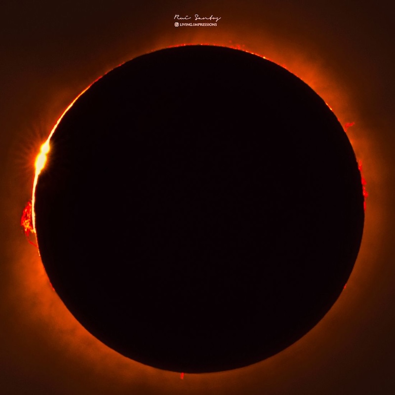 Total solar eclipse with prominences showing around the totally eclipsed sun.