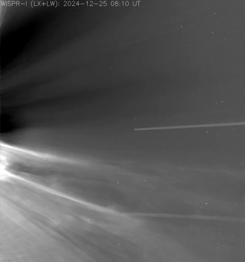 Bright streamers and wisps of solar wind rushing past in grayscale, filmed by Parker Solar Probe near the sun.